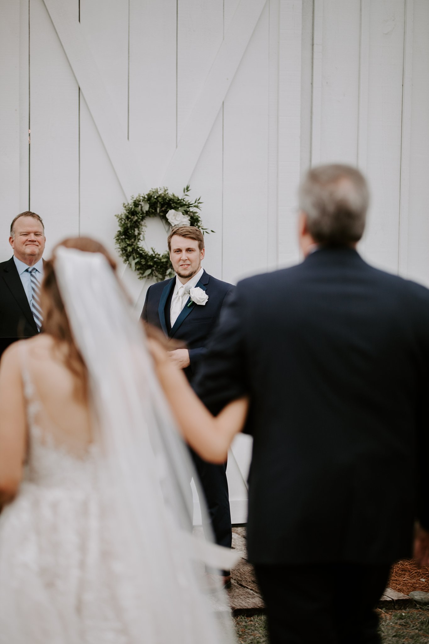 Clifford's smile as he watched Ashley walk towards him during their wedding ceremony at Rosie Creek Farms