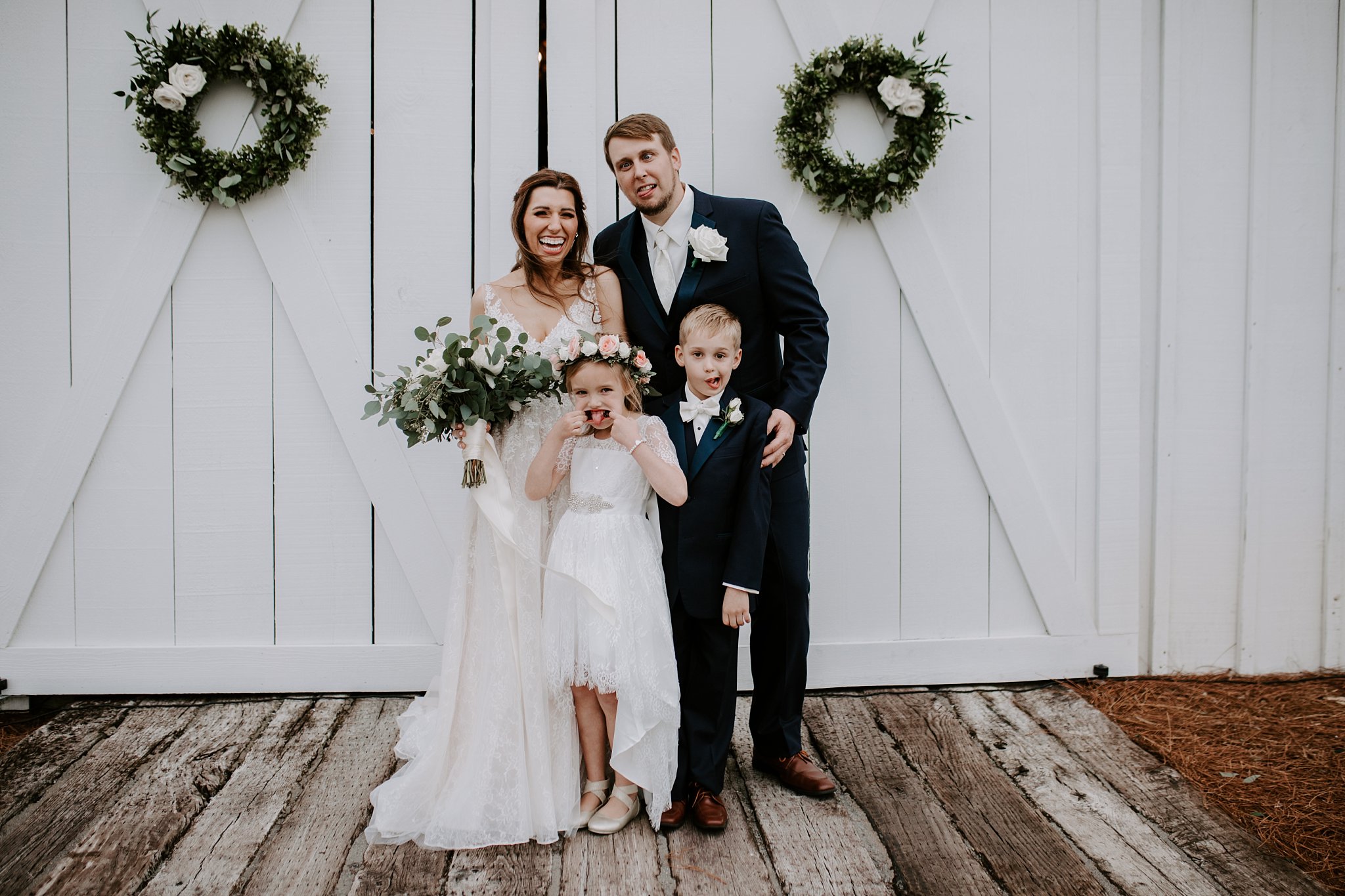 bride, groom, ring bearer and flower girl making silly faces at the camera during formal portraits