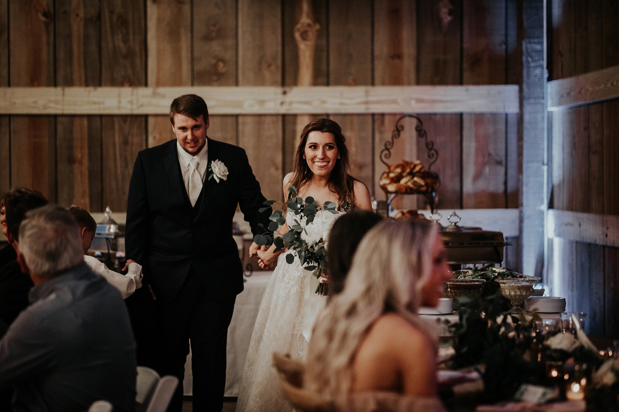 bride and groom make their grand entrance into the barn at Rosie Creek Farms