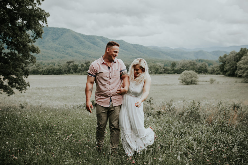 how to plan a destination wedding bride and groom in a field at Cade's Cove