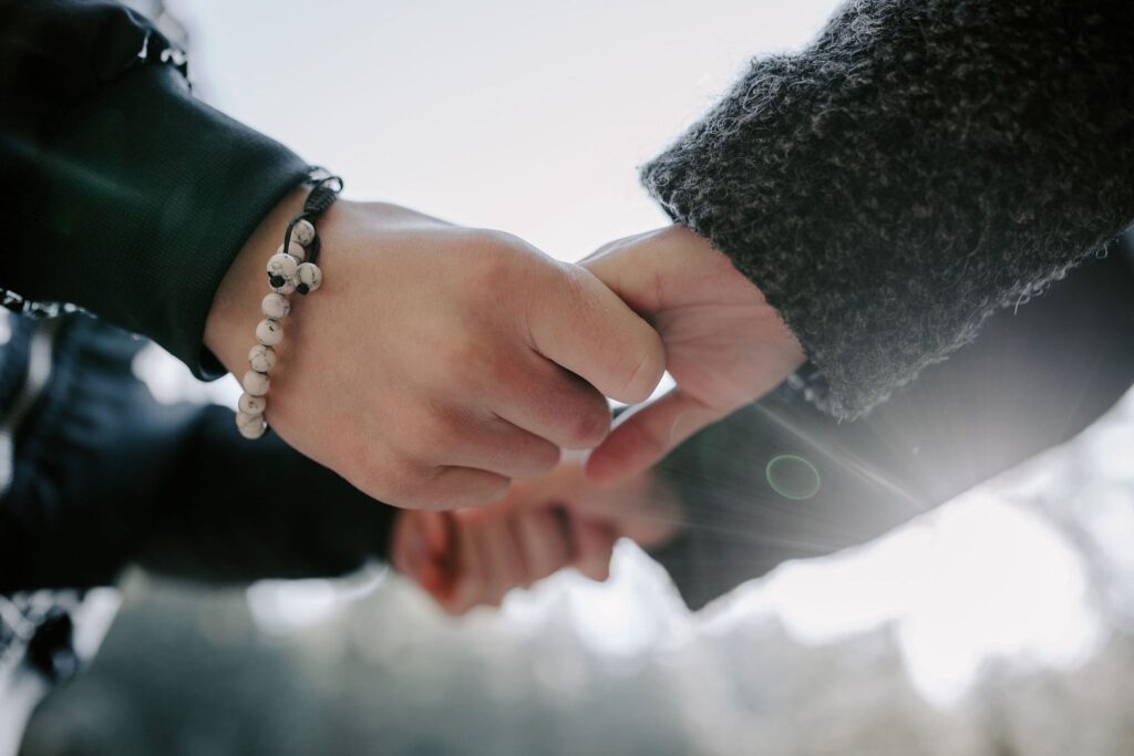 closeup photo of couple holding hands