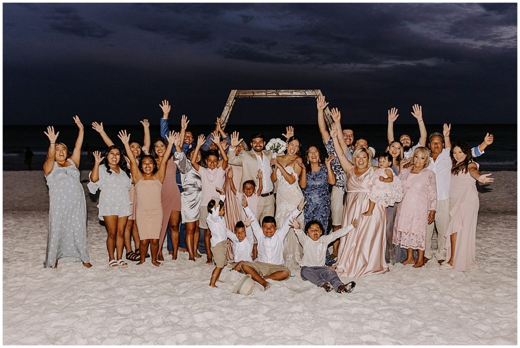 Group shot of everyone at an intimate beach wedding
