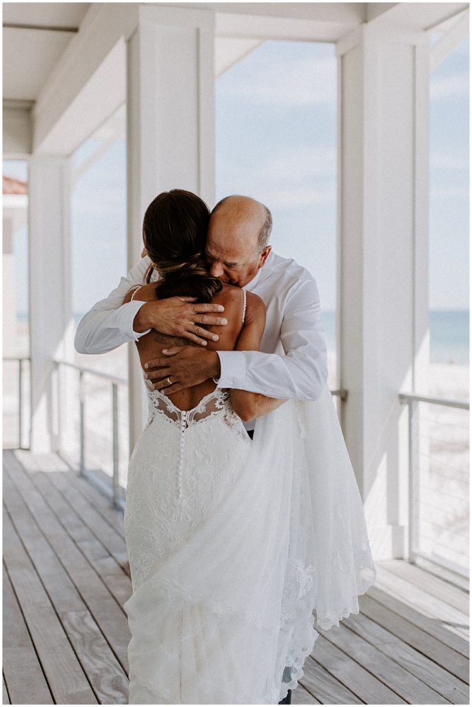 Dad gives the bride a hug after seeing her for the first time 
