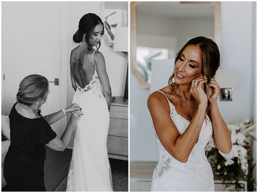 Black and white photo of mom helping bride into her dress, photo of bride putting on her earrings