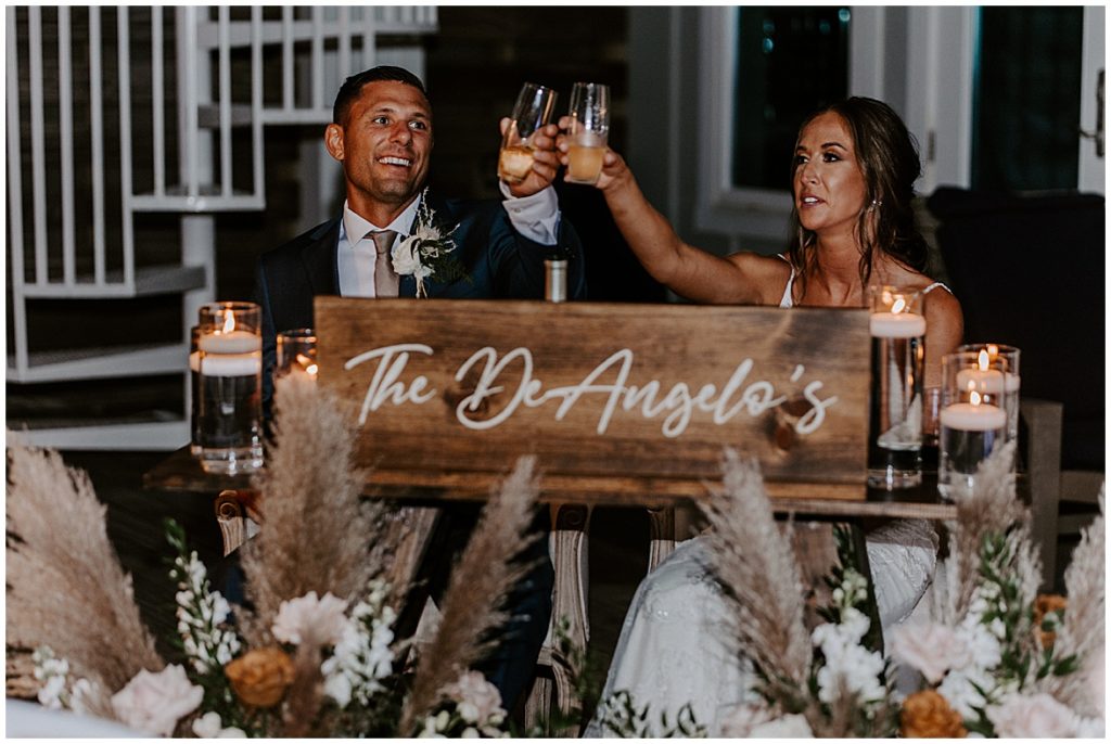 Couple lifts their glasses after a toast