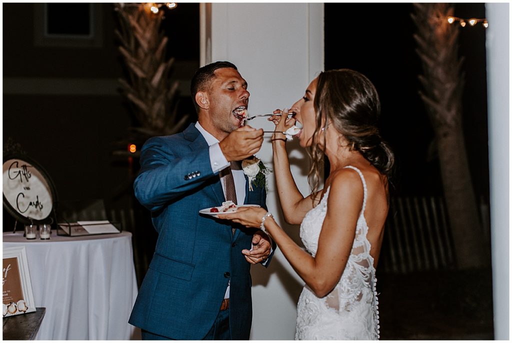Bride and groom feed wedding cake to each other