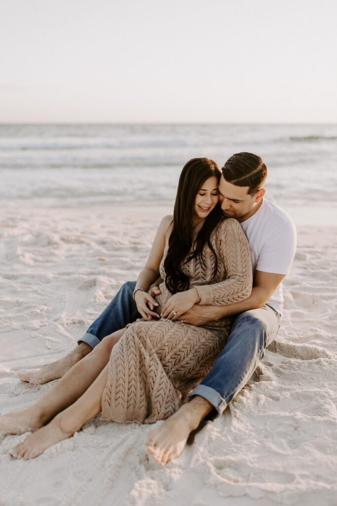 Couple sitting in the sand on the beach