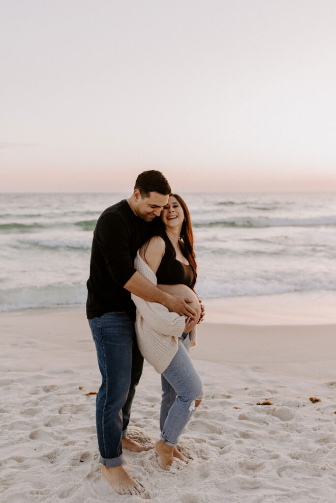 Couple walking on the beach during their destin maternity session