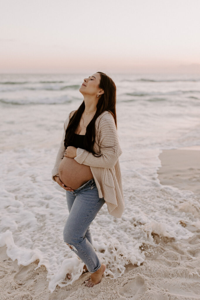 Portrait of a pregnant woman holding her belly