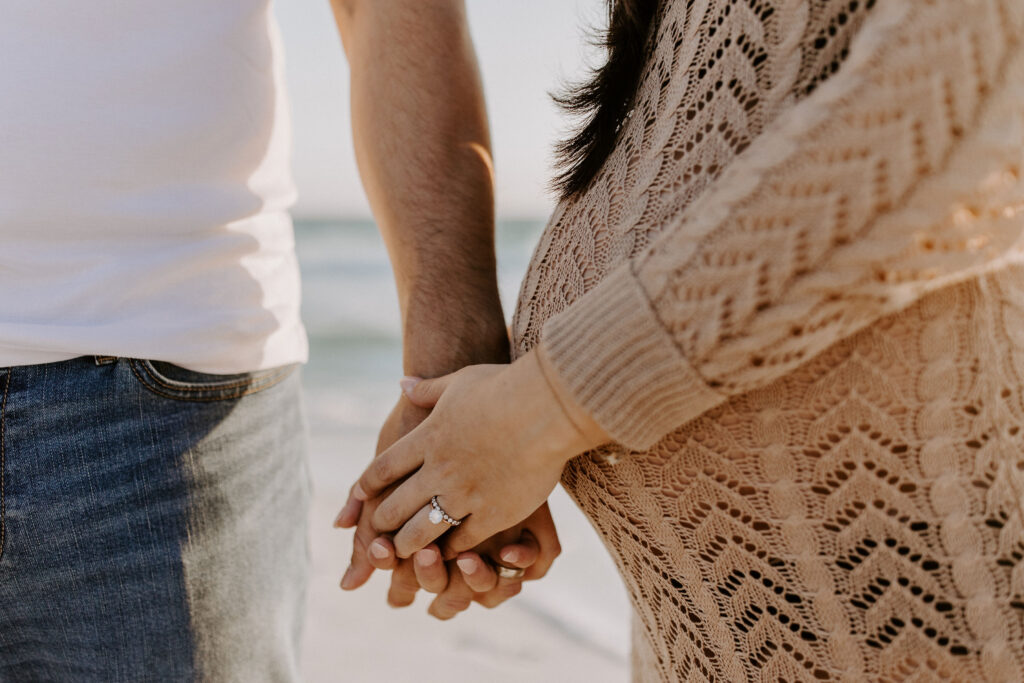 Closeup of couple holding hands