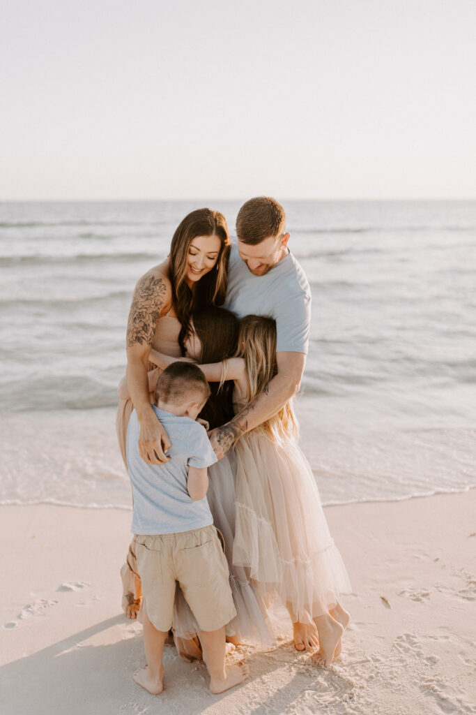 Family hugging on the beach